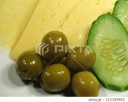 Green olives and cucumber close view background 123389465