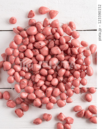 Dried fruits and berries in chocolate glaze. Pink candies on a white wooden background. 123390152