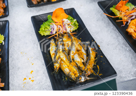 fresh seasoned spicy fish at Asian self-service buffet in the hotel's restaurant for breakfast in Asia in Vietnam fresh seasoned spicy fish at Asian self-service buffet in the hotel's restaurant for breakfast in Asia in Vietnam 123390436