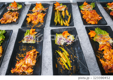 assortment of meat and various Asian vietnamese dishes at buffet in hotel restaurant in Asia assortment of meat and various Asian vietnamese dishes at buffet in hotel restaurant in Asia 123390452