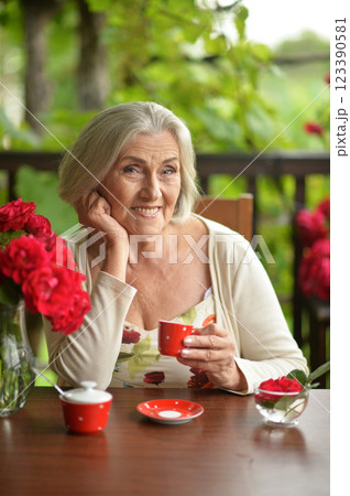 Portrait of happy aged woman drinking coffee Portrait of happy aged woman drinking coffee 123390581