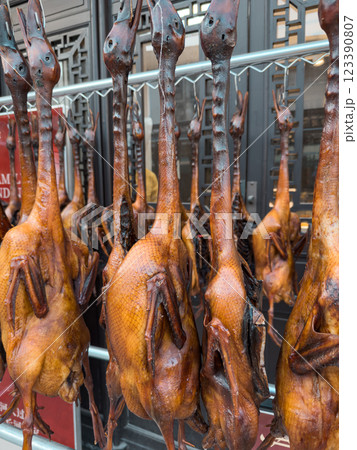 Smoked ducks hanging on display in a street market in a lively city Smoked ducks hanging on display in a street market in a lively city 123390807