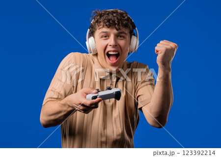 Young adult man playing online video game on console TV with joystick. e-sport 123392214