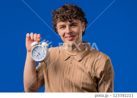 Happy Man With Alarm Clock On Blue Background. Late Morning, Weekend, Finally 123392221