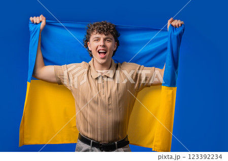 Happy young man with national Ukrainian flag. Ukraine, patriot, victory, fan 123392234