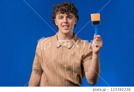 Creative Man Artist Imitates Painting With Brush On Blue Background. Fantasy 123392236