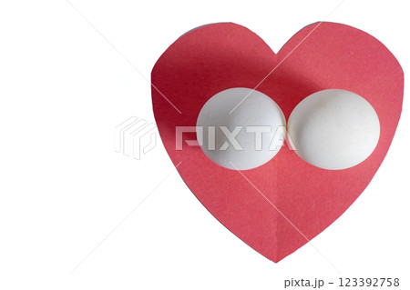 Top view of red heart with eggs on white background Top view of red heart with eggs on white background 123392758