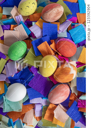 Colorful Easter eggs on a vibrant crepe paper decorative background, top view Colorful Easter eggs on a vibrant crepe paper decorative background, top view 123392904