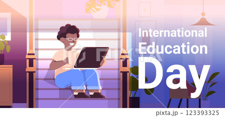 student watching free online courses on laptop international education day live webinar e-learning concept living room interior 123393325