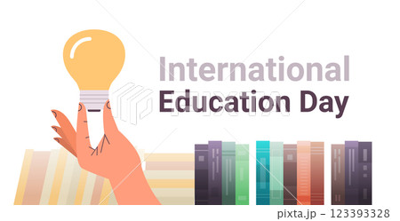 human hand holding light lamp near books new idea innovation international education day concept horizontal human hand holding light lamp near books new idea innovation international education day concept horizontal 123393328