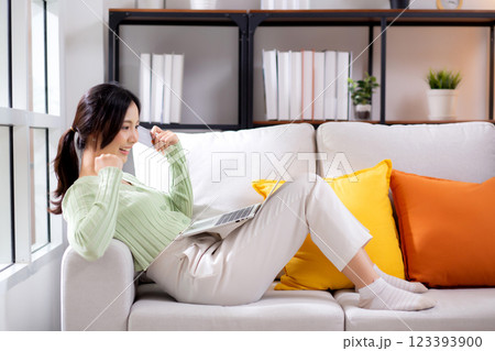Young asian woman sitting on sofa using laptop computer shopping online with credit card. Young asian woman sitting on sofa using laptop computer shopping online with credit card. 123393900