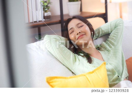 Happy young asian woman relax and leisure sitting on sofa in living room at home. Happy young asian woman relax and leisure sitting on sofa in living room at home. 123393928
