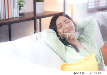 Happy young asian woman relax and leisure sitting on sofa in living room at home. Happy young asian woman relax and leisure sitting on sofa in living room at home. 123393930