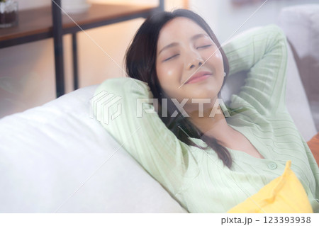 Happy young asian woman relax and leisure sitting on sofa in living room at home. Happy young asian woman relax and leisure sitting on sofa in living room at home. 123393938