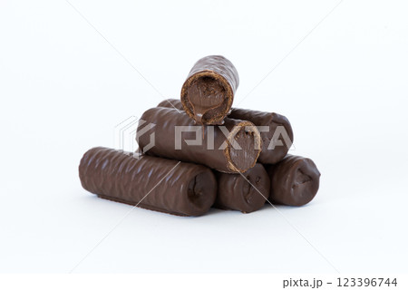 Sweet chocolate covered rolls - table arrangement, isolated on white background. Selective focus. Copy space. 123396744