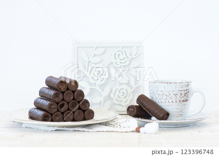 Sweet chocolate covered rolls - table arrangement, isolated on white background. Selective focus. Copy space. 123396748