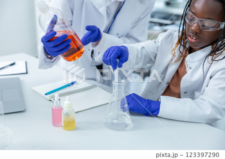 Two people working with the vacutainers in a school laboratory Two people working with the vacutainers in a school laboratory 123397290