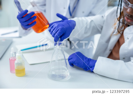 Two people working with the vacutainers in a school laboratory 123397295