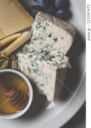 Cheese plate for party with honey, nuts and berries. Cheese plate for party with honey, nuts and berries. 123397472