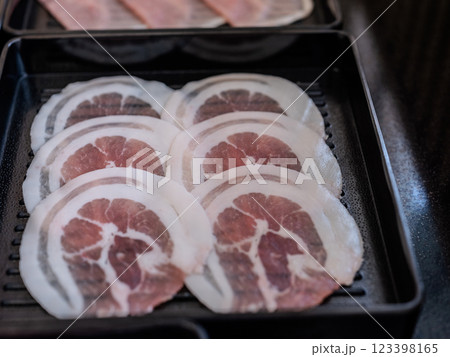 Sliced belly pork for shabu or Japanese hot pot on black tray Sliced belly pork for shabu or Japanese hot pot on black tray 123398165