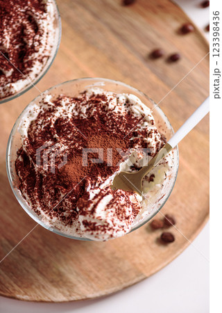 Traditional Italian dessert tiramisu in glasses on white table. Soft focus Traditional Italian dessert tiramisu in glasses on white table. Soft focus 123398436