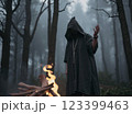 Witch casts a spell in a deep wild forest. Halloween	 123399463