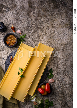 Uncooked lasagna pasta with cooking ingredient Uncooked lasagna pasta with cooking ingredient 123400109