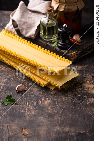 Uncooked lasagna pasta with cooking ingredient 123400218