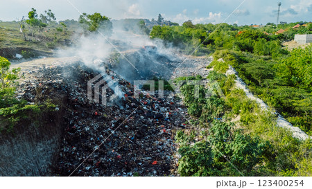 Burning dump in Bali. drone view. Pollution by plastic rubbish on landfill Burning dump in Bali. drone view. Pollution by plastic rubbish on landfill 123400254