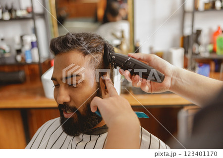 A Barber Expertly Providing a Stylish and Fashionable Haircut Inside a Modern Salon Environment 123401170