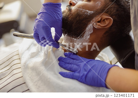 Indulge in a Relaxing Barber Shave Experience with a Traditional Razor for that Ultimate Comfort 123401171