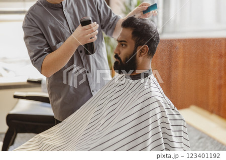 Enjoying a Relaxing Barber Session at a Modern and Stylish Salon for a Perfect Look and Feel 123401192