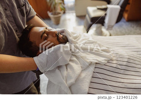 Enjoy a Relaxing Barber Experience that includes a refreshing Facial Treatment for relaxation 123401226