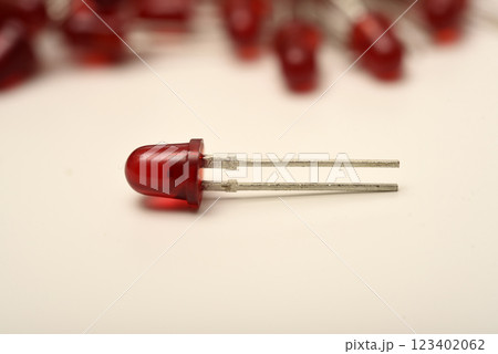 A red LED on the background of a pile of LED elements. One LED. A red LED on the background of a pile of LED elements. One LED. 123402062