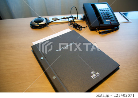 Mainz, Germany, July 8, 2017: Close-Up of Hotel Guest Directory on Desk with Telephone 123402071