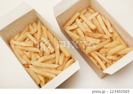 French fries on a cardboard box. Fried potatoes in a package. 123402085