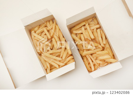 French fries on a cardboard box. Fried potatoes in a package. 123402086