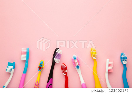 Colorful toothbrushes on pink background with copy space Colorful toothbrushes on pink background with copy space 123402173