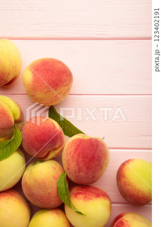 Fresh ripe peaches on pink background, top view. Vertical photo Fresh ripe peaches on pink background, top view. Vertical photo 123402191