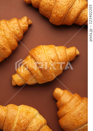 Freshly baked croissants on brown wooden background Warm Fresh Buttery Croissants and Rolls. French and American Croissants and Baked Pastries. Vertical photo. Freshly baked croissants on brown wooden background Warm Fresh Buttery Croissants and Rolls. French and American Croissants and Baked Pastries. Vertical photo. 123402205
