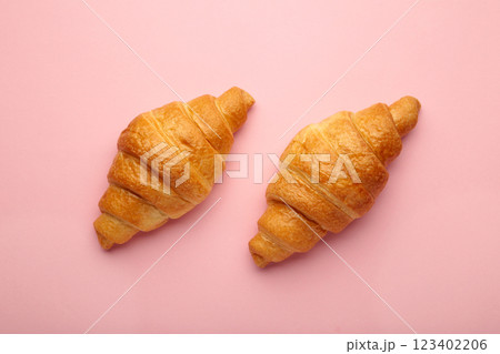 Freshly baked croissants on pink background. French and American Croissants and Baked Pastries 123402206