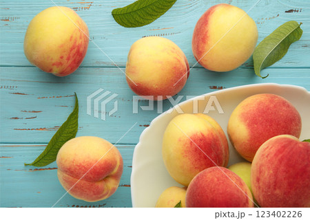 Plate of ripe peaches on blue background. Plate of ripe peaches on blue background. 123402226