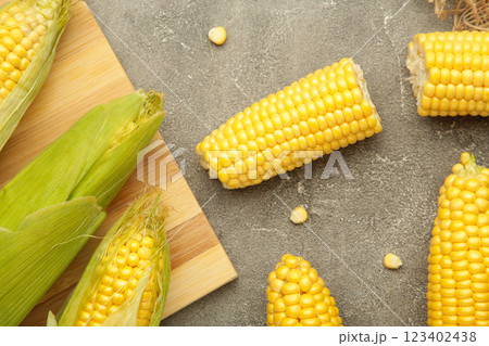 Fresh corn on cobs on grey background. Top view Fresh corn on cobs on grey background. Top view 123402438