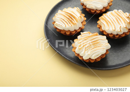 Appetizing lemon cupcakes with white cream on beige background. Holiday, surprise, birthday, Valentine's Day. 123403027