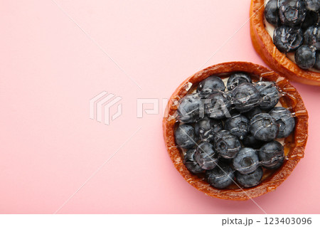 Blueberry tartlets on pink background. Homemade tarts with black berries. 123403096