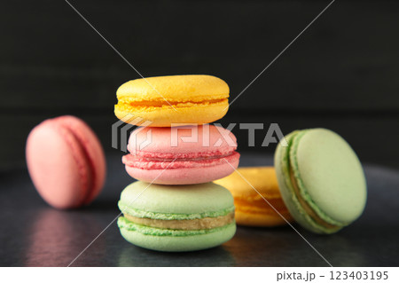 Colorful macarons cakes on dark background. Small French cakes. Sweet and colorful french macaroons. 123403195