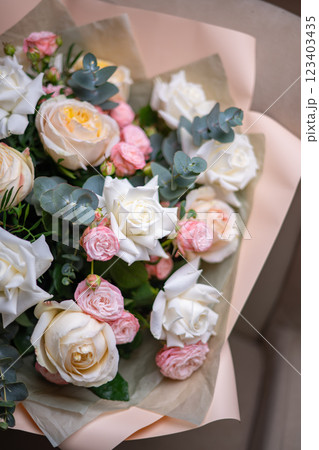 A Stunning Arrangement Featuring a Beautiful Bouquet of Pink and White Roses Alongside Lilies 123403435