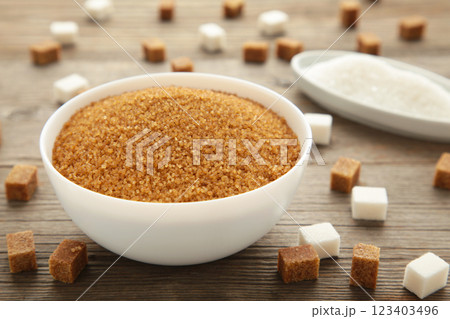 White and brown sugar in bowl on grey background. Vertical photo 123403496