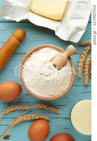 Ingredients for baking or cooking, egg flour, rolling pin butter, milk on a blue wooden background Cookie pie or cake recipe. Ingredients for baking or cooking, egg flour, rolling pin butter, milk on a blue wooden background Cookie pie or cake recipe. 123403502