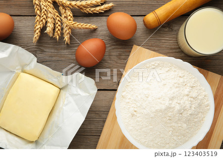 Ingredients for baking or cooking, egg flour, rolling pin butter, milk on a grey wooden background Cookie pie or cake recipe. 123403519